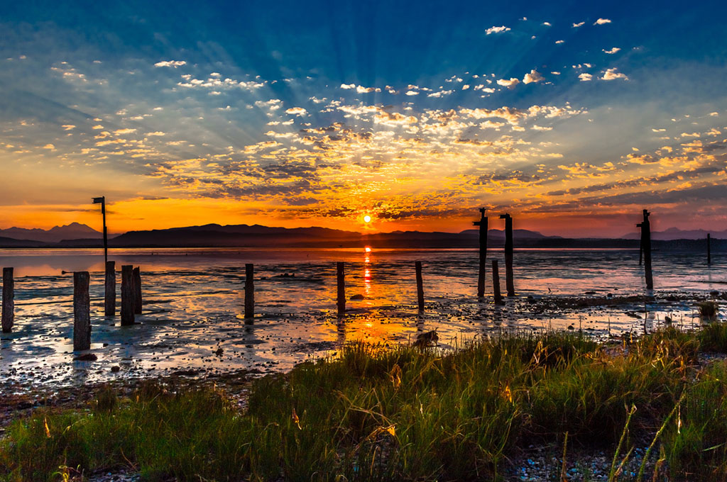 Orange sunrise over water at Camano Island, Washington.